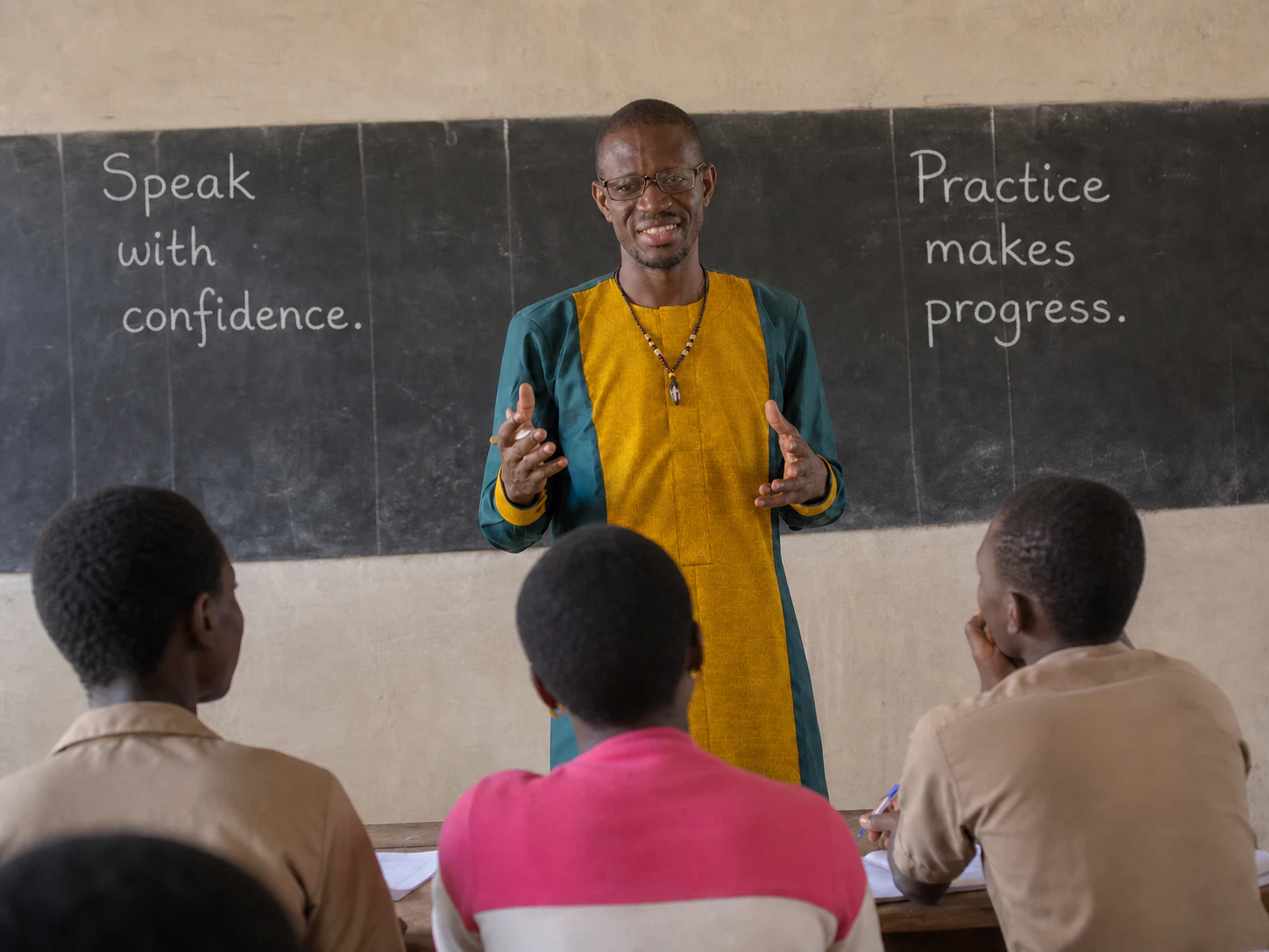 Coach Sika teaching in front of a blackboard